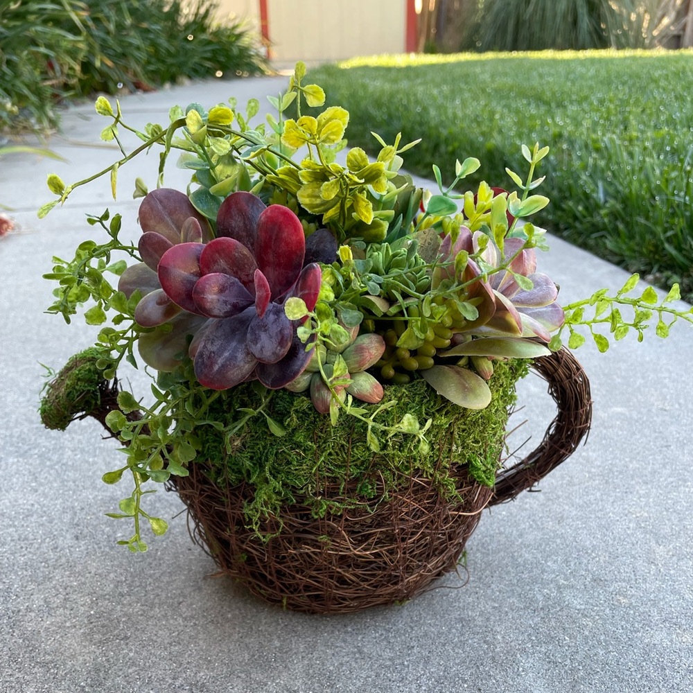 Vine Watering Can filled with faux greenery, succulents & sola wood succulents.